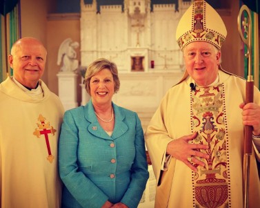 Archbishop Mitchell Rozanski, Nancy Blattner, and Msgr. Michael Turek at the Centennial celebration Mass.